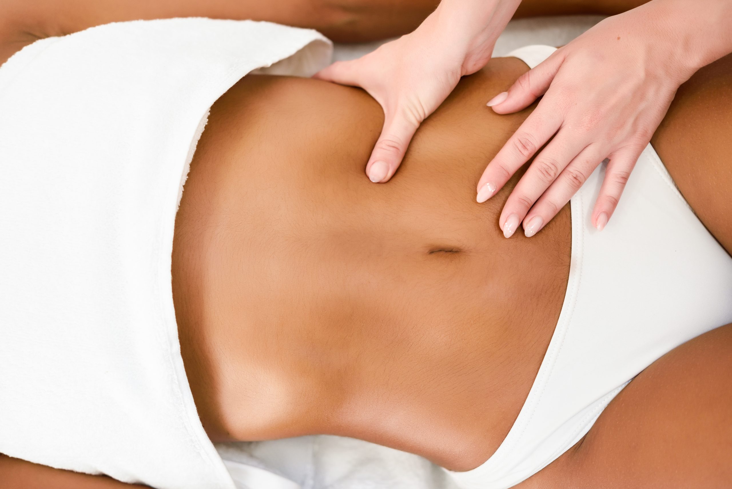woman receiving abdomen massage spa wellness center scaled